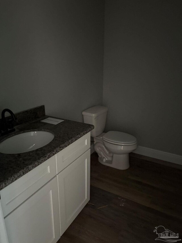 7147 Heath Rd, Milton, FL 32570 - bathroom with wood finished floors, vanity, and toilet
