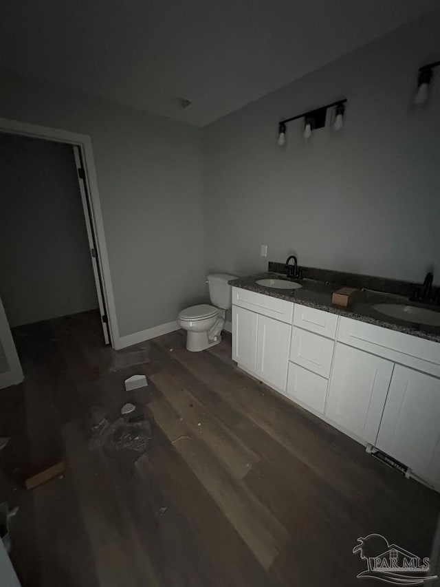 7147 Heath Rd, Milton, FL 32570 - bathroom with wood finished floors, toilet, and double vanity