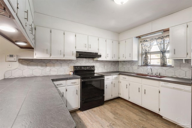 kitchen with dishwasher, backsplash, black / electric stove, under cabinet range hood, and a sink