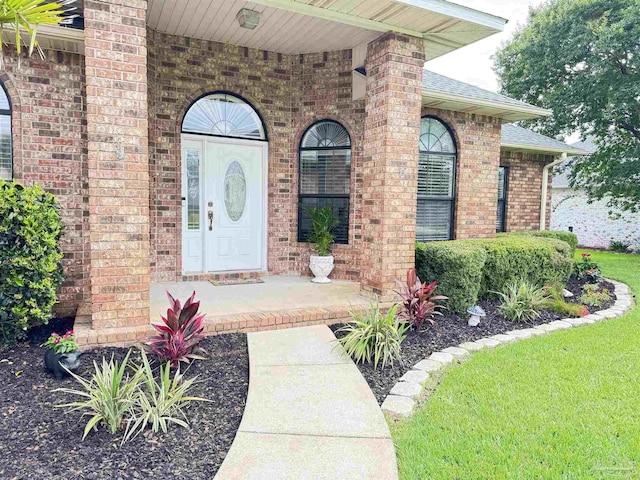3849 Saber Tooth Cir, Gulf Breeze, FL 32563 - entrance to property with brick siding, roof with shingles, and covered porch