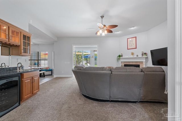 3849 Saber Tooth Cir, Gulf Breeze, FL 32563 - living area with wine cooler, light colored carpet, ceiling fan, and a tile fireplace
