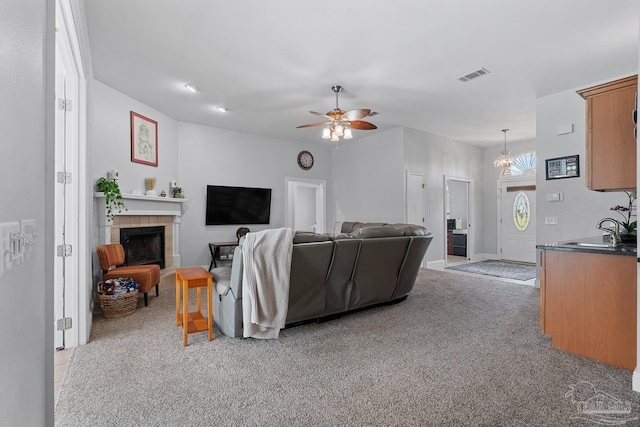 3849 Saber Tooth Cir, Gulf Breeze, FL 32563 - living room with ceiling fan, a tiled fireplace, and light colored carpet