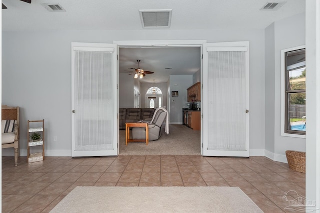3849 Saber Tooth Cir, Gulf Breeze, FL 32563 - tiled living room featuring a ceiling fan and carpet flooring