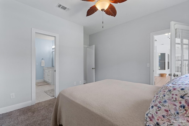 3849 Saber Tooth Cir, Gulf Breeze, FL 32563 - bedroom with light tile patterned floors, ensuite bathroom, light carpet, and ceiling fan
