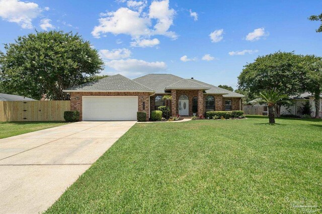 3849 Saber Tooth Cir, Gulf Breeze, FL 32563 - view of front of home with a garage, concrete driveway, brick siding, and a shingled roof