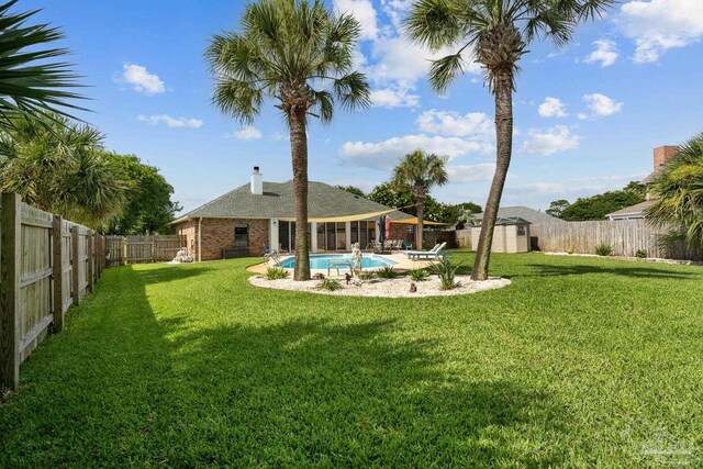 3849 Saber Tooth Cir, Gulf Breeze, FL 32563 - fenced backyard featuring a storage unit