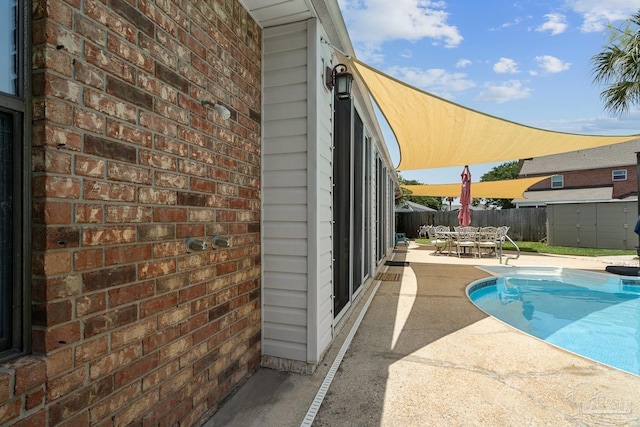 3849 Saber Tooth Cir, Gulf Breeze, FL 32563 - view of pool featuring a patio, outdoor dining area, and a storage shed