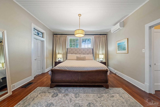 bedroom with a wall unit AC, dark hardwood / wood-style flooring, and crown molding