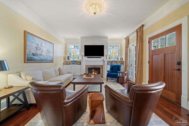 living room featuring an inviting chandelier, hardwood / wood-style floors, and ornamental molding