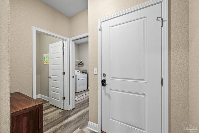 12561 Lillian Hwy, Pensacola, FL 32506 - doorway featuring washer / dryer, a textured wall, wood finished floors, and baseboards