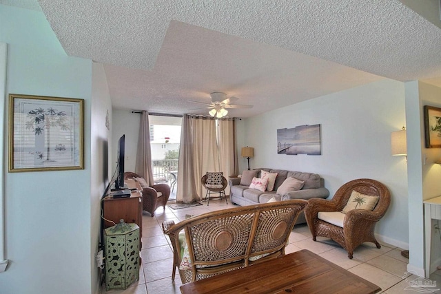 tiled living room with a textured ceiling and ceiling fan