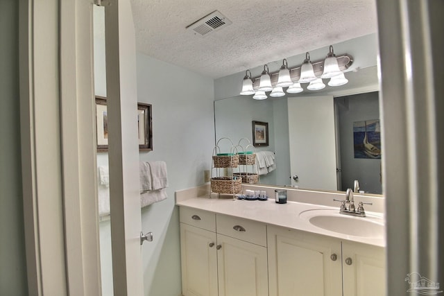 bathroom featuring vanity and a textured ceiling