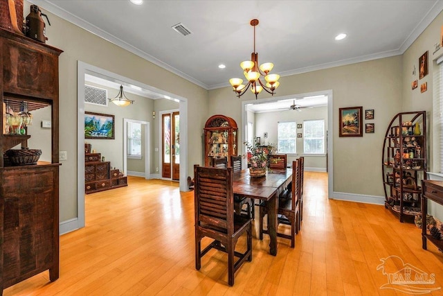 dining room featuring crown molding, ceiling fan with notable chandelier, and light hardwood / wood-style floors