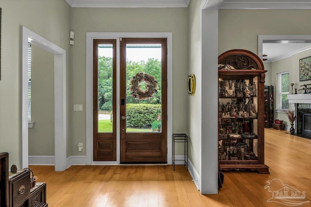 entryway featuring light hardwood / wood-style flooring and crown molding