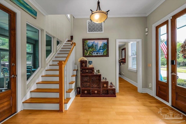 entrance foyer with light wood-type flooring and crown molding