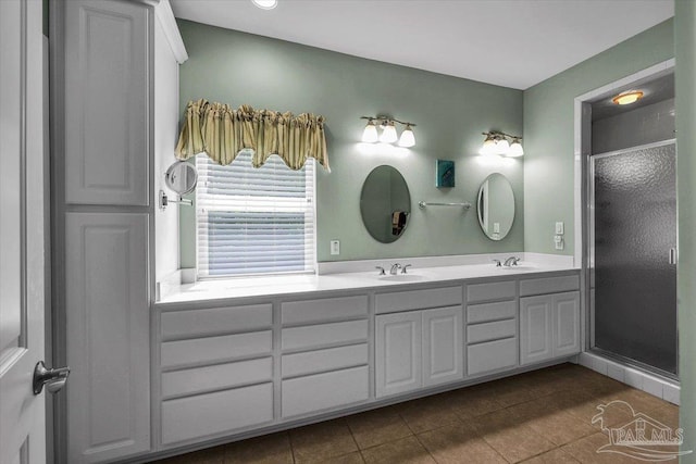 bathroom featuring tile patterned flooring, vanity, and a shower with door