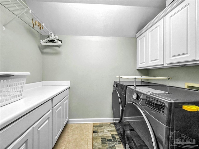 laundry area featuring cabinets and washer and dryer