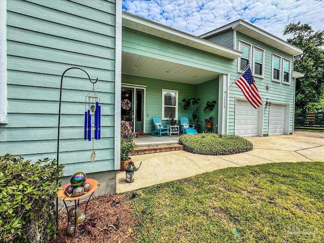 exterior space featuring covered porch and a garage