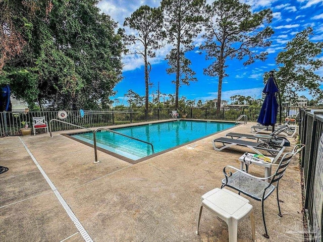 view of swimming pool with a patio area