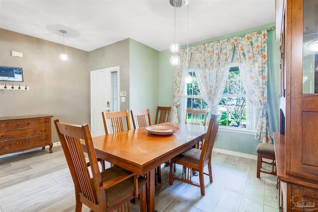 7543 Loop St, Navarre, FL 32566 - dining room featuring light wood-style flooring and baseboards