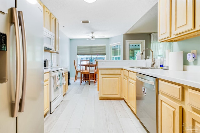 7543 Loop St, Navarre, FL 32566 - kitchen with white appliances, light brown cabinets, ceiling fan, a peninsula, and light countertops
