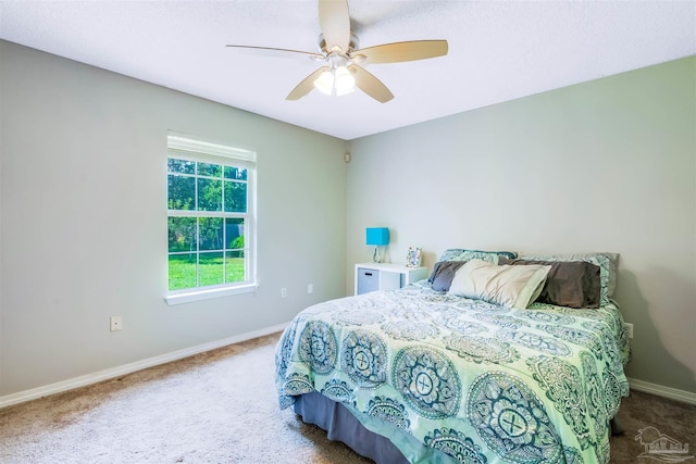 7543 Loop St, Navarre, FL 32566 - carpeted bedroom with baseboards and ceiling fan