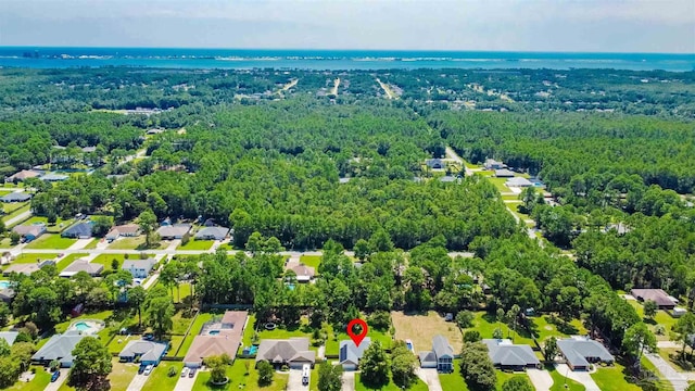 7543 Loop St, Navarre, FL 32566 - aerial perspective of suburban area featuring a heavily wooded area and a nearby body of water