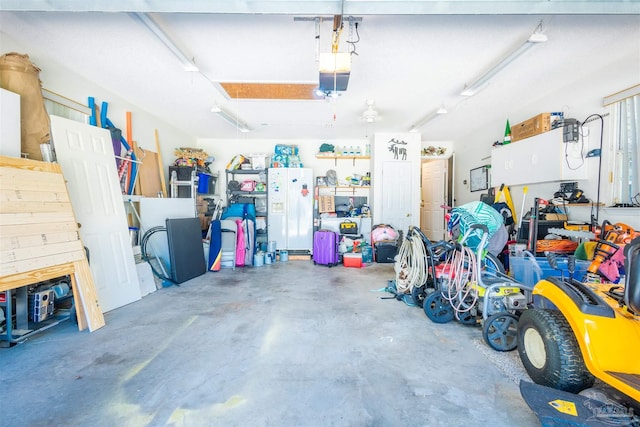 7543 Loop St, Navarre, FL 32566 - garage featuring white fridge with ice dispenser and a garage door opener