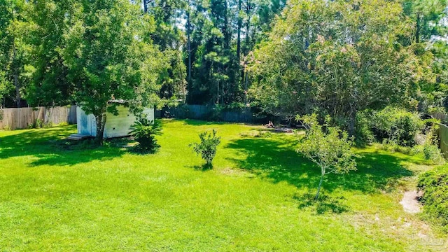 7543 Loop St, Navarre, FL 32566 - fenced backyard with a storage unit