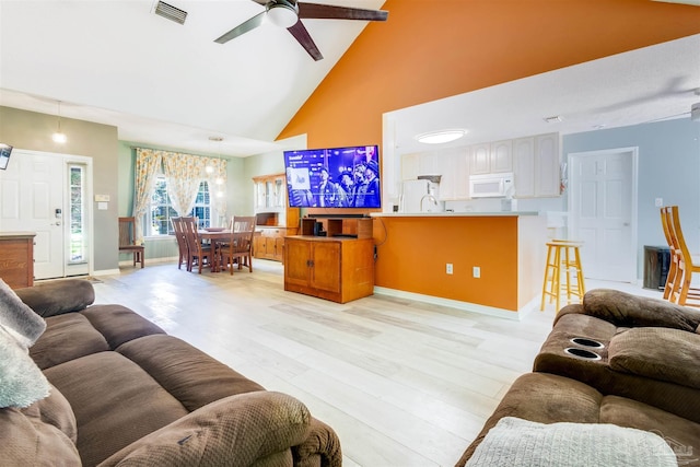 7543 Loop St, Navarre, FL 32566 - living area with high vaulted ceiling, light wood-type flooring, and ceiling fan
