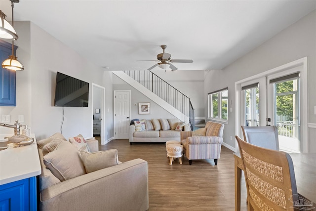 living room featuring ceiling fan, french doors, and dark wood-type flooring