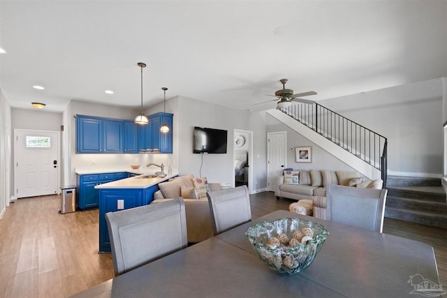 dining room featuring hardwood / wood-style floors, ceiling fan, and sink