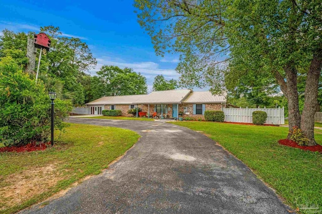 2931 Pine Forest Rd, Cantonment, FL 32533 - ranch-style house with driveway, metal roof, and brick siding
