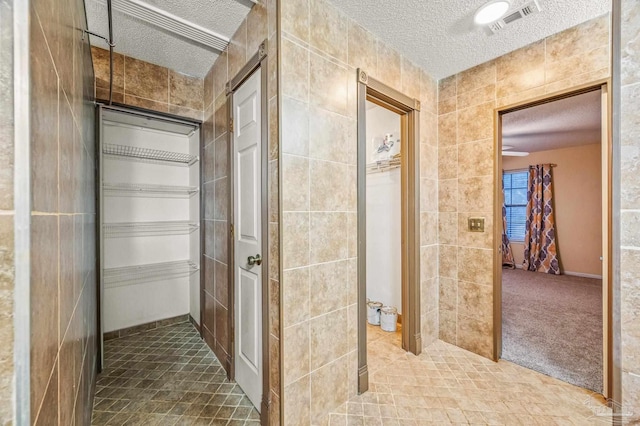2931 Pine Forest Rd, Cantonment, FL 32533 - hallway featuring a textured ceiling and tile patterned flooring