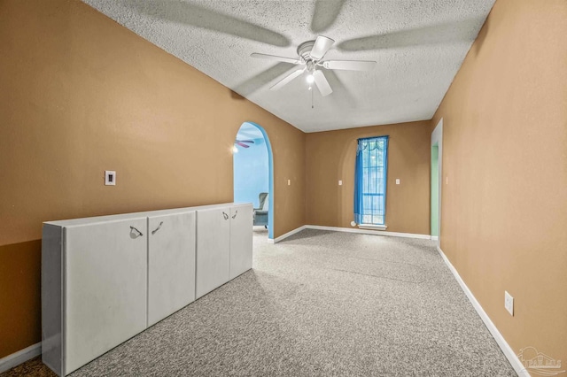 2931 Pine Forest Rd, Cantonment, FL 32533 - carpeted spare room featuring ceiling fan, a textured ceiling, baseboards, and arched walkways