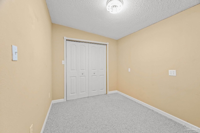 2931 Pine Forest Rd, Cantonment, FL 32533 - unfurnished bedroom with a textured ceiling, carpet flooring, baseboards, and a closet