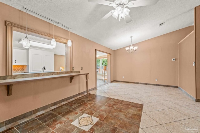 2931 Pine Forest Rd, Cantonment, FL 32533 - kitchen featuring a textured ceiling, a breakfast bar area, ceiling fan, lofted ceiling, and a chandelier
