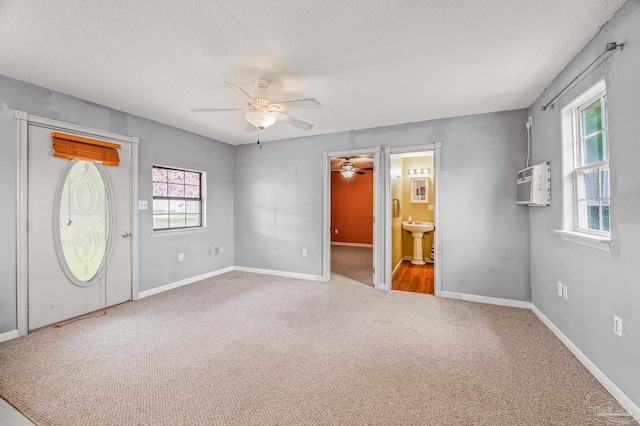2931 Pine Forest Rd, Cantonment, FL 32533 - entryway with a ceiling fan, carpet flooring, an AC wall unit, a textured ceiling, and baseboards