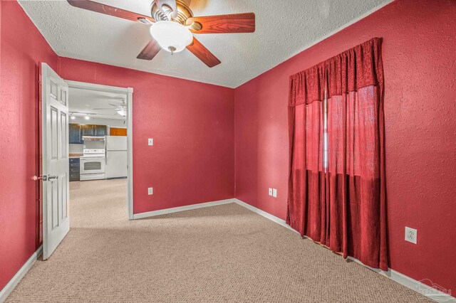 2931 Pine Forest Rd, Cantonment, FL 32533 - carpeted spare room featuring ceiling fan, a textured ceiling, baseboards, and a textured wall