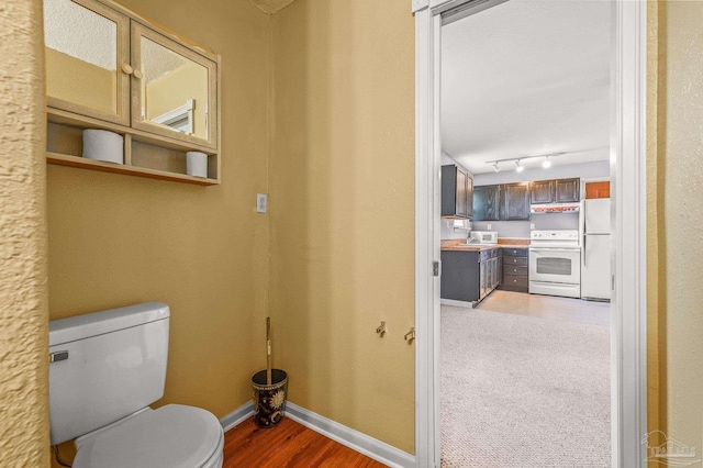 2931 Pine Forest Rd, Cantonment, FL 32533 - bathroom featuring baseboards, toilet, and wood finished floors
