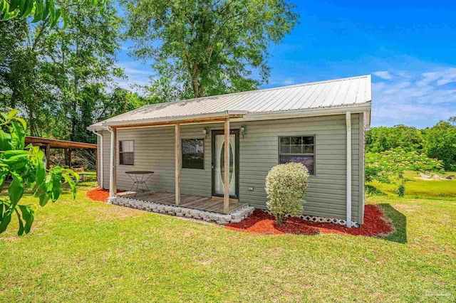 2931 Pine Forest Rd, Cantonment, FL 32533 - view of front of house featuring a porch, a front lawn, and metal roof