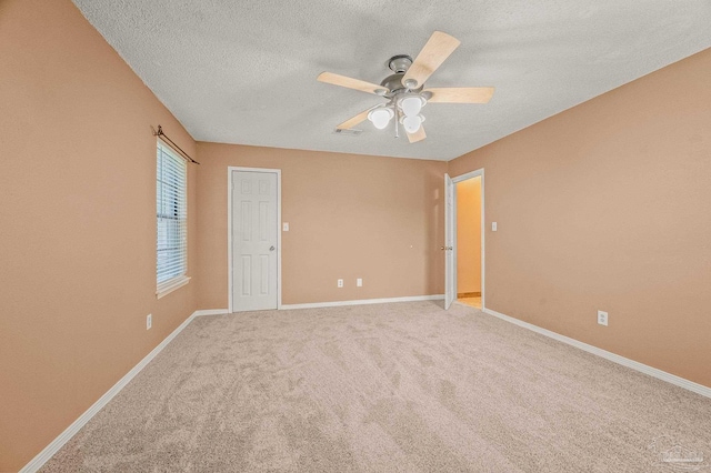 2931 Pine Forest Rd, Cantonment, FL 32533 - spare room with a ceiling fan, light colored carpet, a textured ceiling, and baseboards