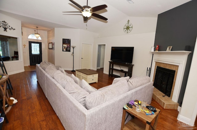 living room featuring vaulted ceiling, a tiled fireplace, ceiling fan, and hardwood / wood-style flooring