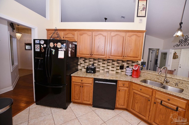 kitchen with light hardwood / wood-style floors, sink, vaulted ceiling, hanging light fixtures, and black appliances