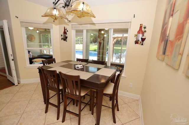 dining space with an inviting chandelier and light tile patterned flooring