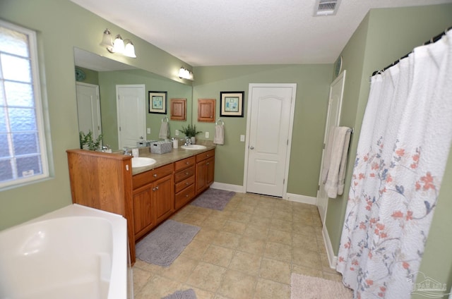 bathroom featuring vanity and a textured ceiling