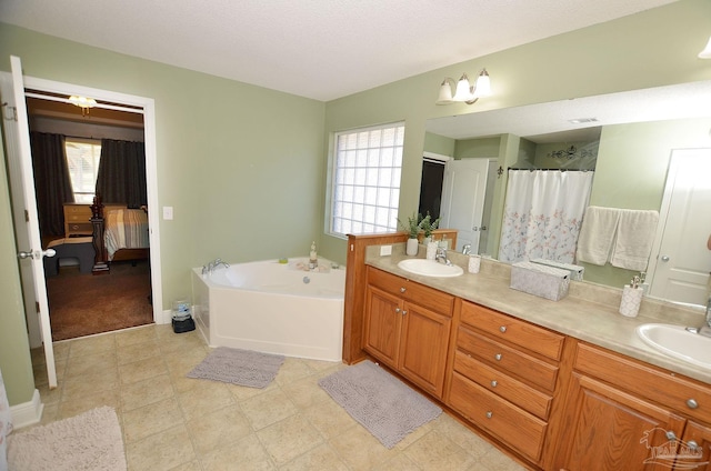 bathroom featuring shower with separate bathtub, a textured ceiling, and vanity