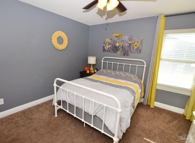 bedroom featuring dark colored carpet and ceiling fan