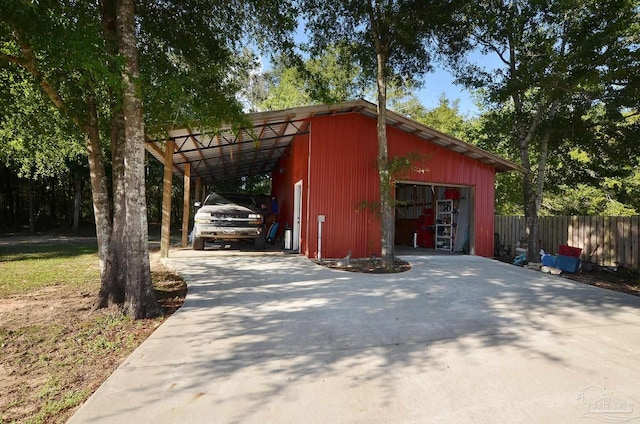 view of outbuilding featuring a garage and a carport