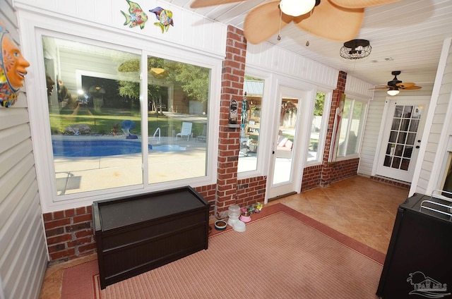 sunroom / solarium featuring ceiling fan